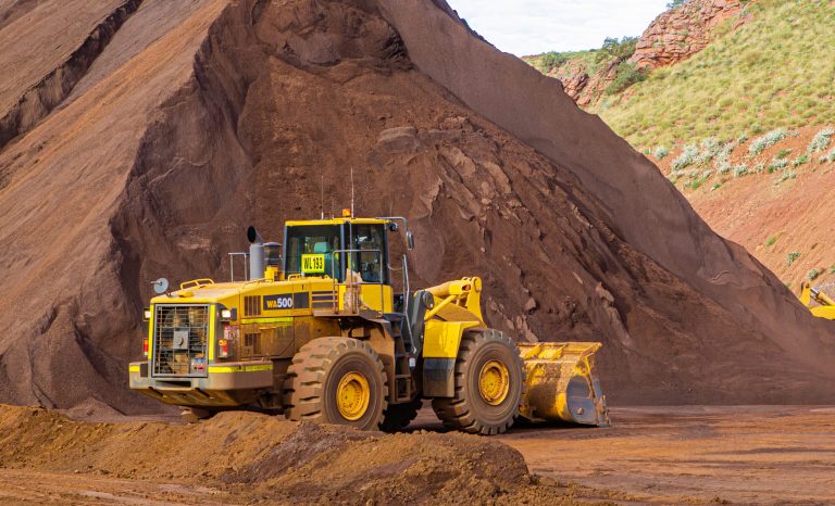 Loader,Next,To,Stock,Pile,At,Mine,Site