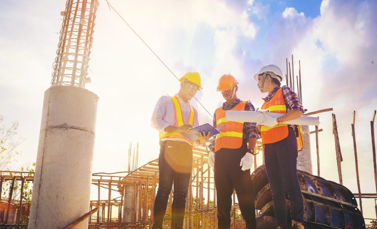 Structural,Engineer,Or,Architect,And,Foreman,Worker,With,Blueprints,Discuss,