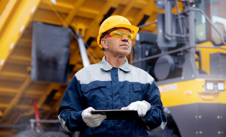 Coal,Mining,Worker,Use,Tablet,Computer,On,Background,Big,Yellow