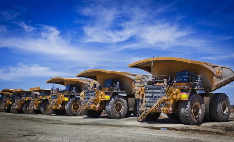 Massive,Yellow,Excavation,Trucks,Lined,Up.,Used,For,Transporting,Mine